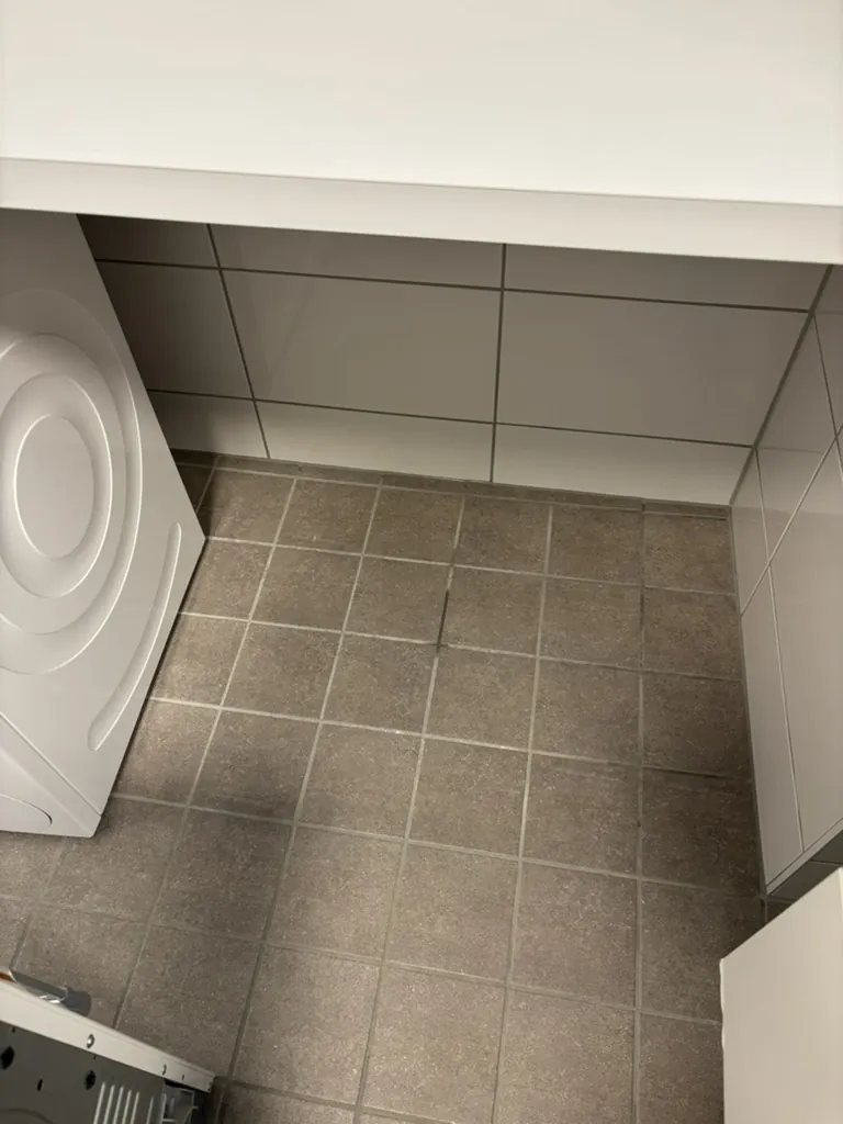 Floor under the washing machine after cleaning, clean