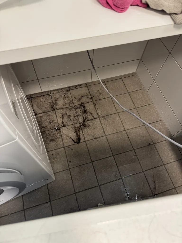Floor under the washing machine before cleaning, dirty